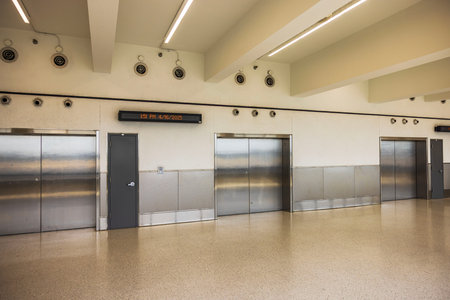Closed platform doors to airport train with digital time display inside Miami International Airport...