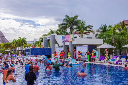 Beautiful view of pool party at Breathless Punta Cana resort with performers and tourists relaxing on background. Dominican Republic. Punta Cana.のeditorial素材
