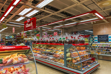 Beautiful view of supermarket chark section with Christmas gift baskets above assorted meat products.のeditorial素材