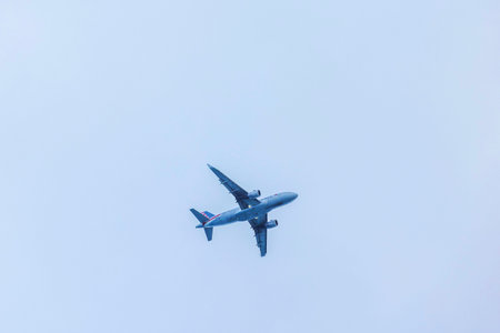 Beautiful view of American Airlines passenger airplane flying high against clear blue sky. Miami...
