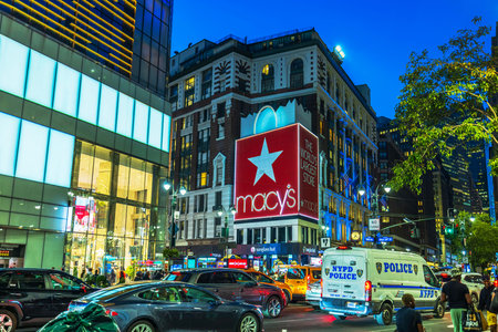 Night view of Macy's store at Broadway and West 34 Street in Manhattan with NYPD police van and...