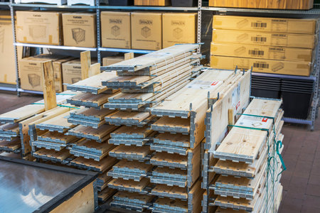 Close up view of foldable raised garden beds stacked in flat packed form with hinge system in garden center.のeditorial素材
