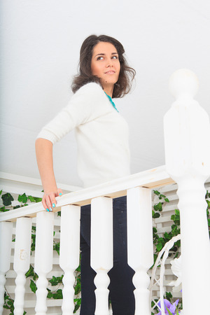 cute young woman relaxing on a porchの写真素材