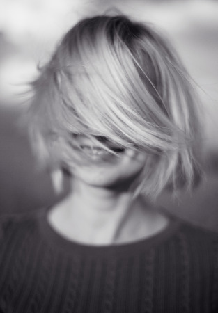Girl in motion with disheveled hairの写真素材