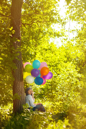 Young woman with balloonsの写真素材