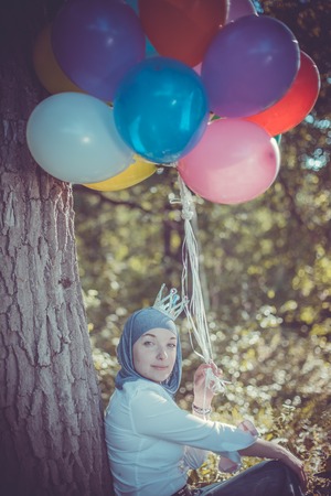 Young woman with balloonsの写真素材