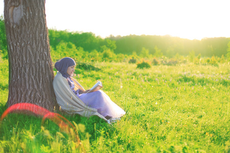 Reading a book in Natureの写真素材