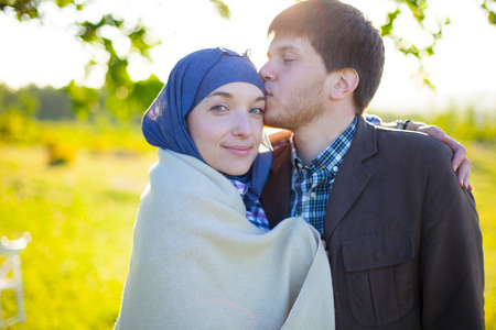 Cute young couple smiling at camera in the parkの写真素材