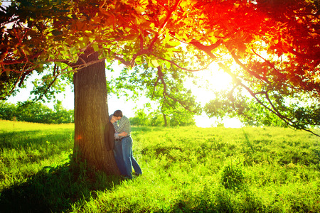 Romantic young couple relaxing outdoors in parkの写真素材