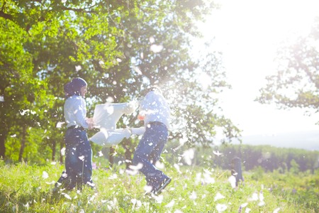 couple having a fun pillow fightの写真素材