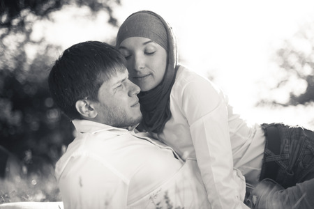 Romantic young couple relaxing outdoors in parkの写真素材