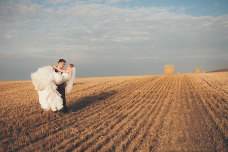 Happy young couple on wheat field の写真素材