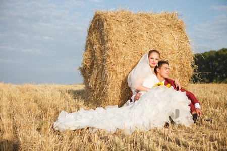 Romantic bride and groom on wheat field の写真素材