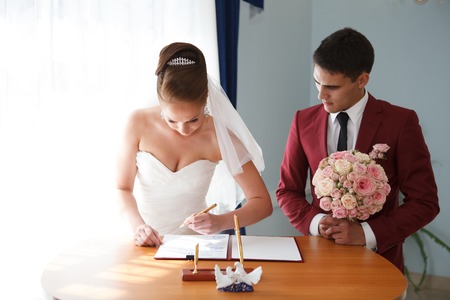 couple signing the wedding registerの写真素材