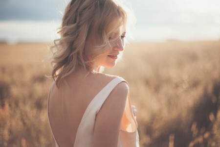 Beautiful blond girl at the wheat fieldの写真素材