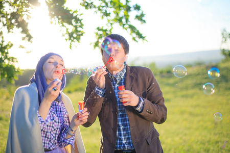 Charming couple blowing bubblesの写真素材