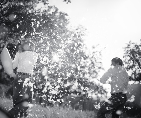 couple having a fun pillow fightの写真素材