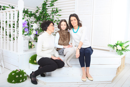 Cute little girl, her mother and grandmother together on this portraitの写真素材