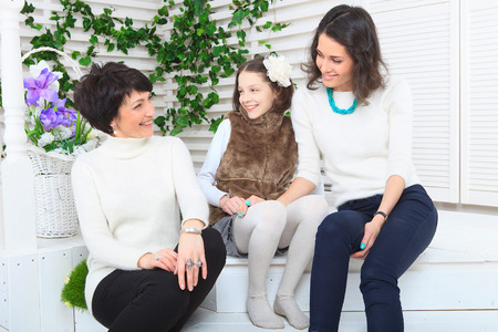 Cute little girl, her mother and grandmother together on this portraitの写真素材