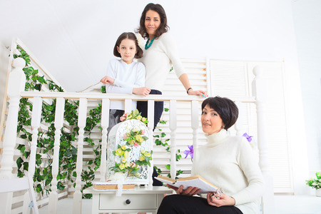 Cute little girl, her mother and grandmother together on this portraitの写真素材