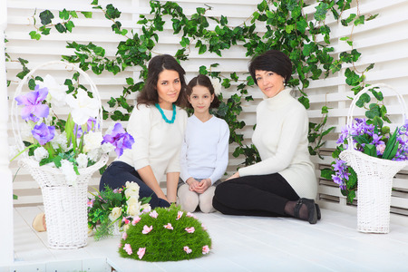 Cute little girl, her mother and grandmother together on this portraitの写真素材