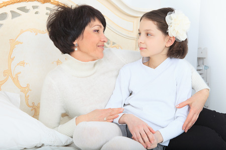 mother and daughter in bedの写真素材