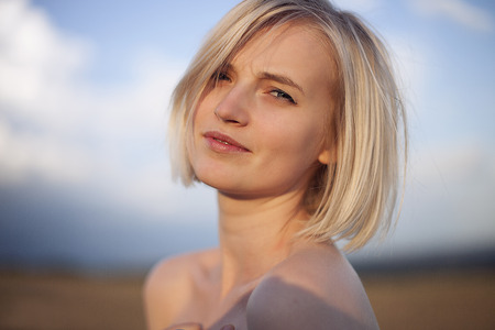 Portrait of a girl at sunset in the fieldの写真素材