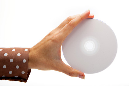 Woman holding a white CD (DVD) on whiteの写真素材