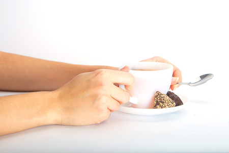 Woman holding hot tea cup on whiteの写真素材