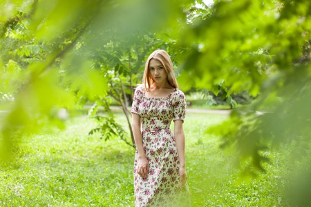 Attractive Young Woman Walking in The Parkの写真素材