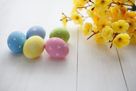 Colorful decorated easter eggs on white wood background. Happy Easter.