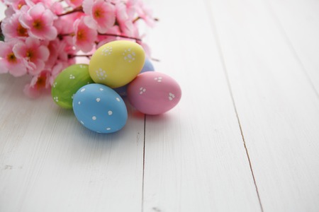 Colorful decorated easter eggs on white wood background. Happy Easter.の写真素材