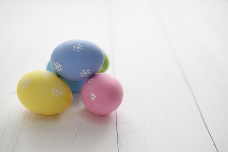 Colorful decorated easter eggs on white wood background. Happy Easter.の写真素材