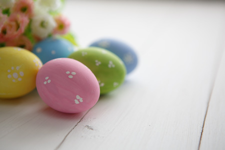 Colorful decorated easter eggs on white wood background. Happy Easter.の写真素材