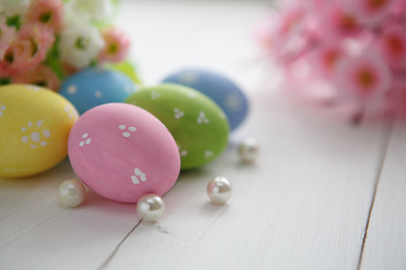 Colorful decorated easter eggs on white wood background. Happy Easter.の写真素材