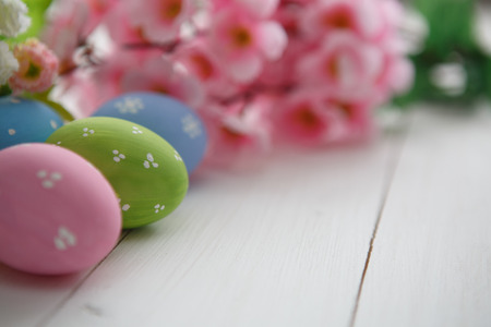 Colorful decorated easter eggs on white wood background. Happy Easter.の写真素材