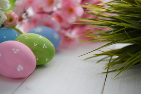 Colorful decorated easter eggs on white wood background. Happy Easter.の写真素材