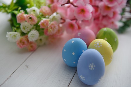 Colorful decorated easter eggs on white wood background. Happy Easter.の写真素材