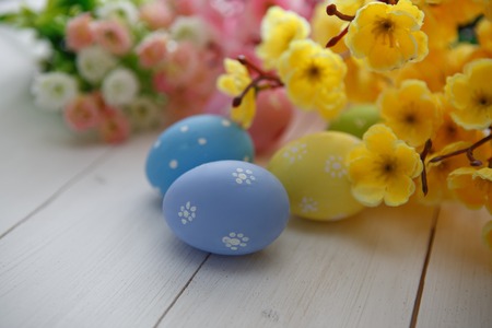 Colorful decorated easter eggs on white wood background. Happy Easter.の写真素材