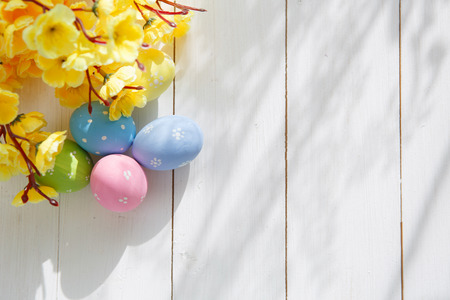 Colorful decorated easter eggs on white wood background. Happy Easter.の写真素材