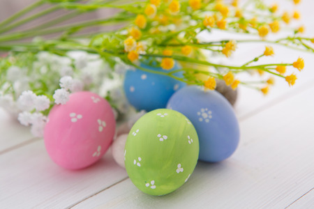 Colorful decorated easter eggs on white wood background. Happy Easter.の写真素材