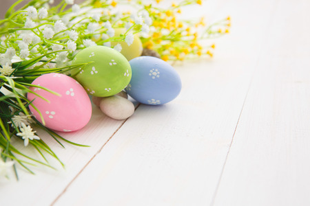 Colorful decorated easter eggs on white wood background. Happy Easter.の写真素材