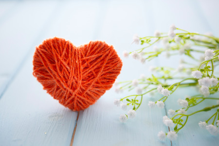 sign with hearts and spring tree blossoms hanging on wood backgroundの写真素材