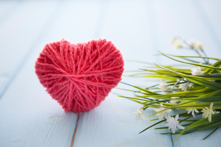 sign with hearts and spring tree blossoms hanging on wood backgroundの写真素材