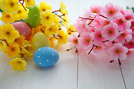 Colorful decorated easter eggs on white wood background. Happy Easter.の写真素材