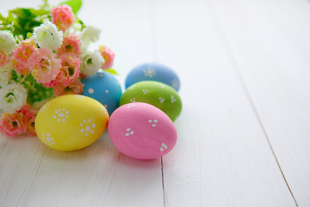 Colorful decorated easter eggs on white wood background. Happy Easter.の写真素材