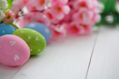 Colorful decorated easter eggs on white wood background. Happy Easter.の写真素材