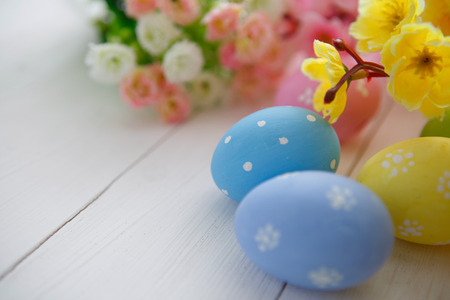 Colorful decorated easter eggs on white wood background. Happy Easter.の写真素材