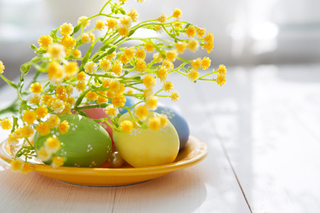 Colorful decorated easter eggs on white wood background. Happy Easter.の写真素材