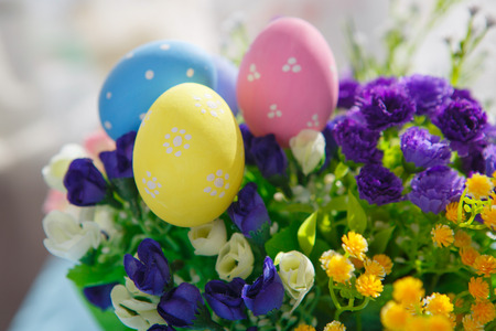 Colorful decorated easter eggs on flowers background. Happy Easter.の写真素材